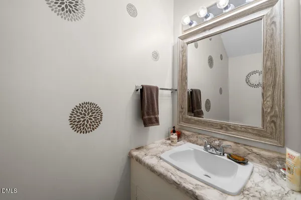 a bathroom with a sink vanity and a mirror
