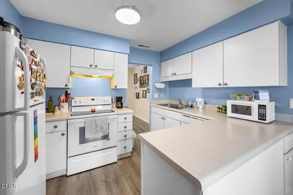 a kitchen with a white cabinets and white appliances