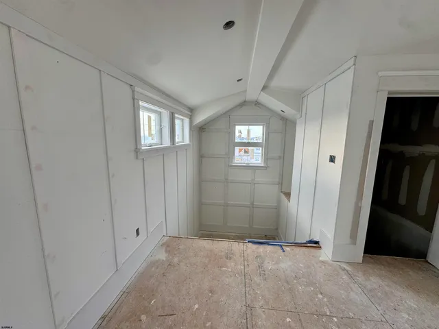 a view of an empty room with windows