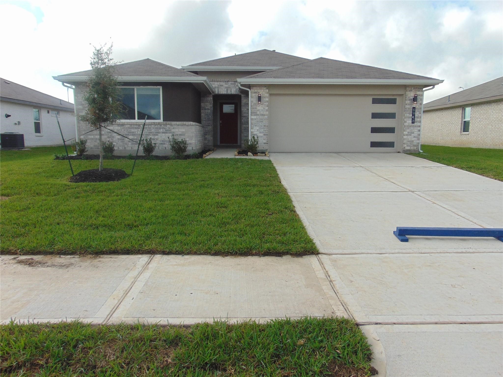 a front view of house with yard and green space