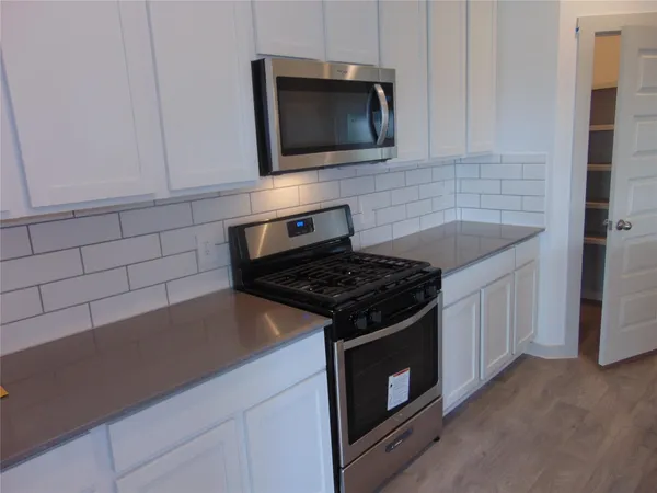 a kitchen with a sink and refrigerator