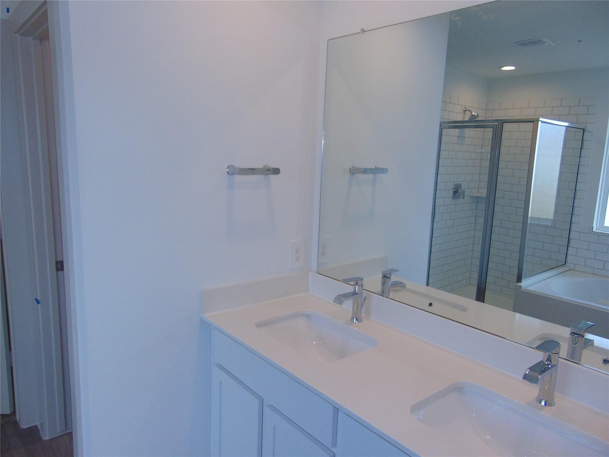 6918 Morales Way Richmond, TX 77469 - Photo 7 of 17 a bathroom with a sink and a large mirror