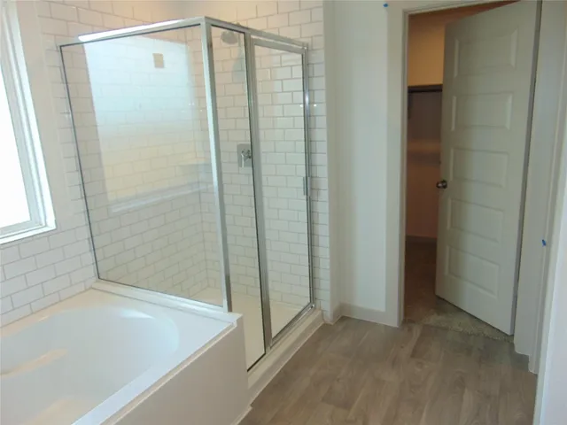 a bathroom with a bathtub and a shower