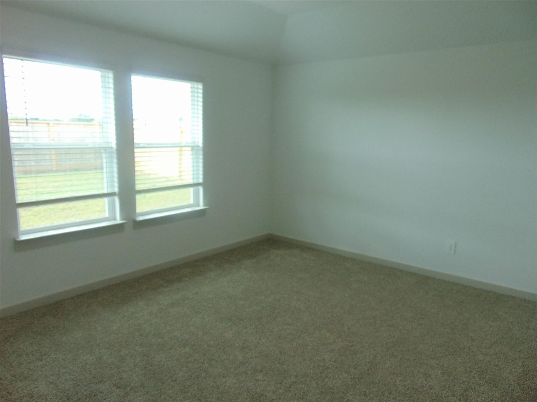 6918 Morales Way Richmond, TX 77469 - Photo 10 of 17 an empty room with a window