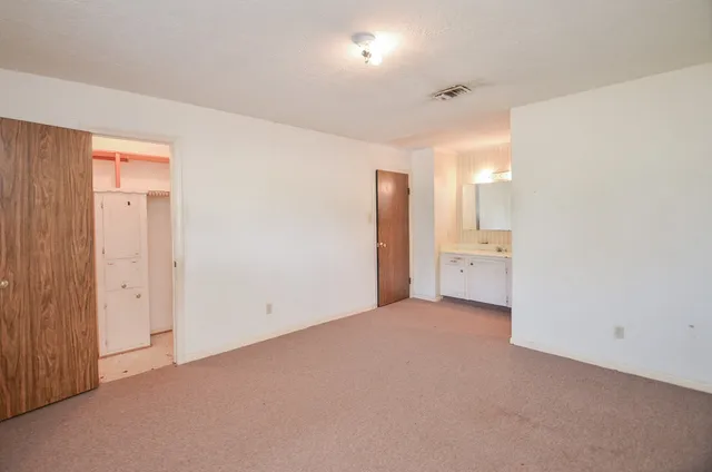 a bathroom with a sink tub double vanity and a mirror