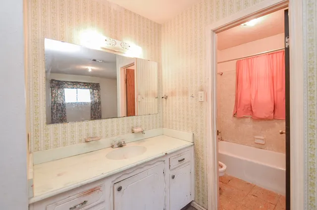 a bathroom with a bathtub and shower