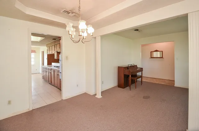 a large kitchen with stainless steel appliances granite countertop a lot of counter space and a sink