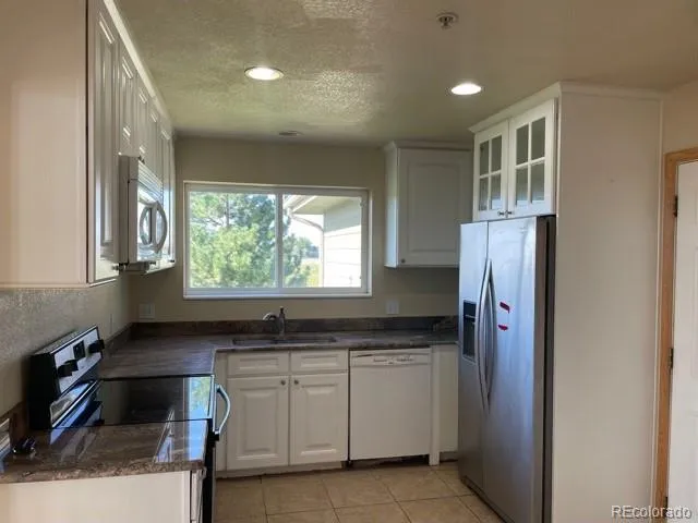 a kitchen with a refrigerator and a sink