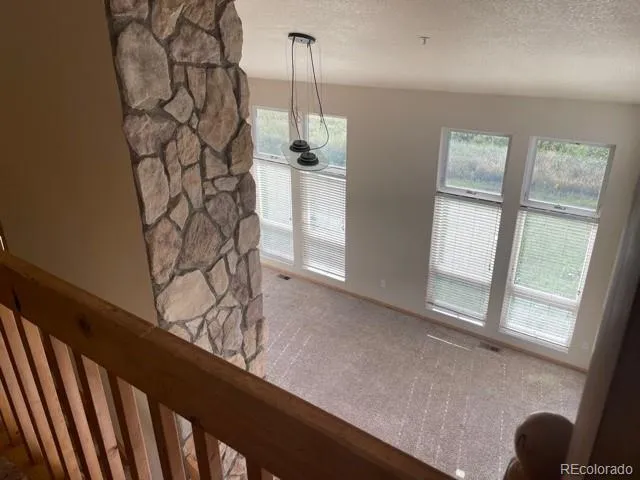 a view of a room with wooden floor and windows