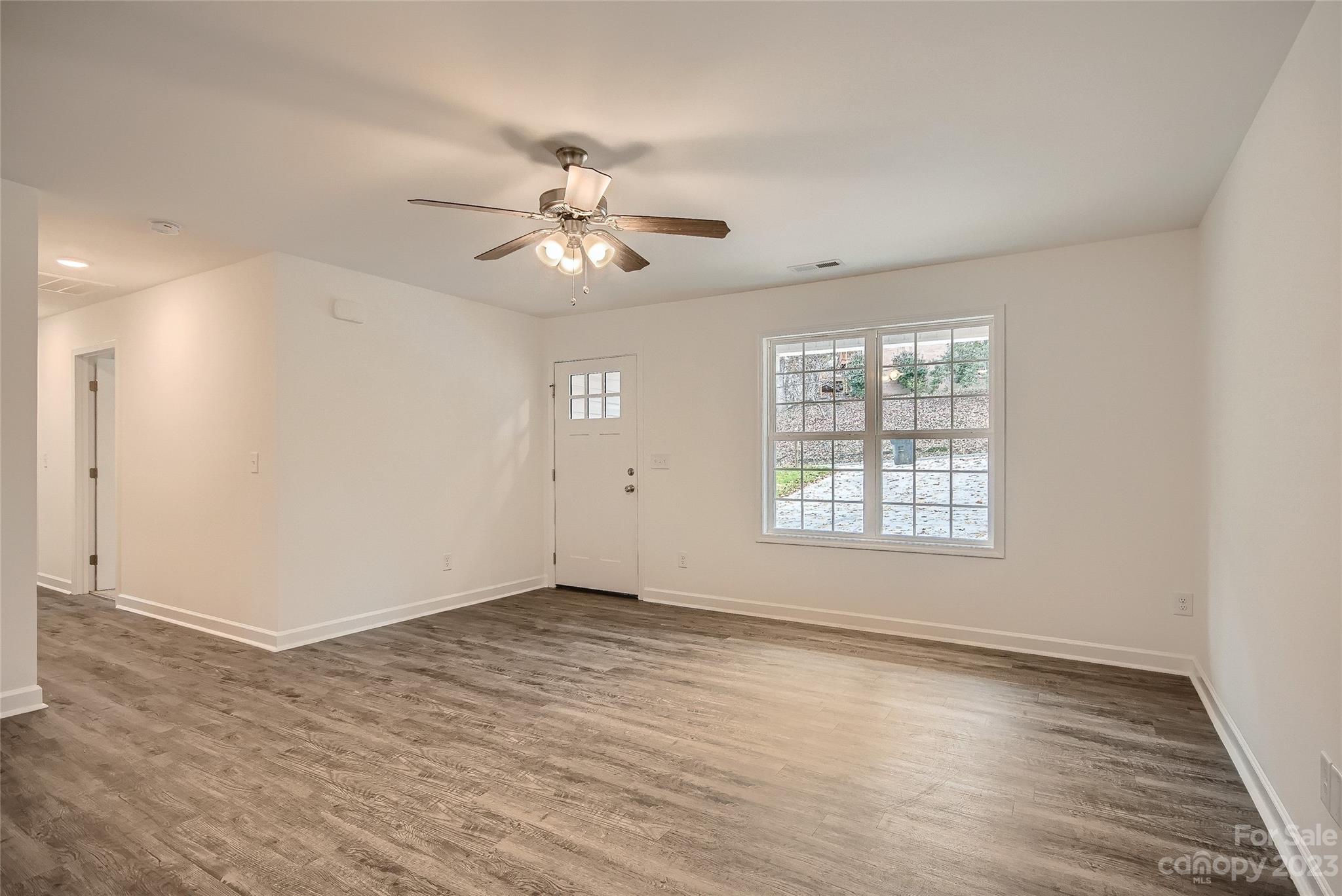 1526 Shepard Street Kannapolis, NC 28083 - Photo 2 of 10 wooden floor in an empty room with a window