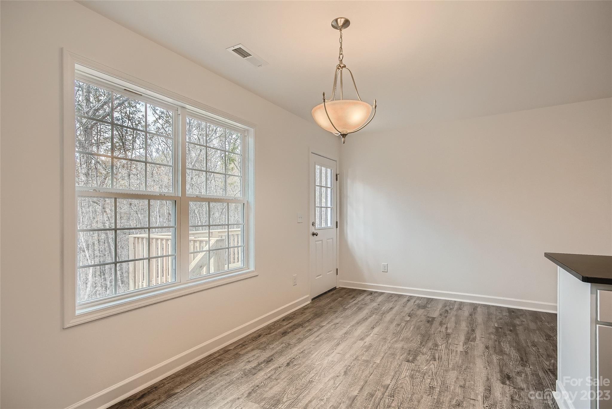 1526 Shepard Street Kannapolis, NC 28083 - Photo 3 of 10 a view of empty room with wooden floor and window