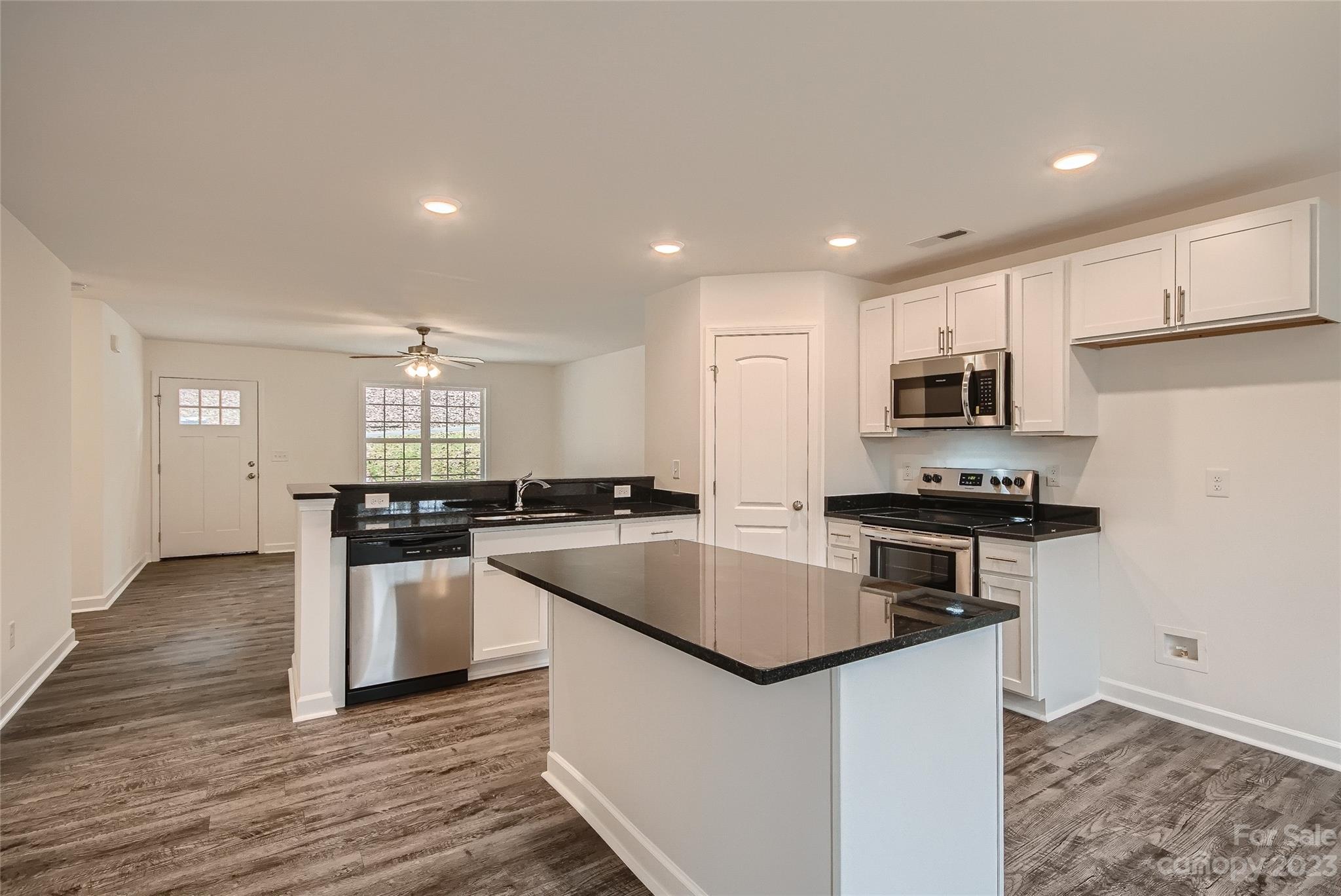 1526 Shepard Street Kannapolis, NC 28083 - Photo 4 of 10 a kitchen with stainless steel appliances granite countertop a sink stove and refrigerator