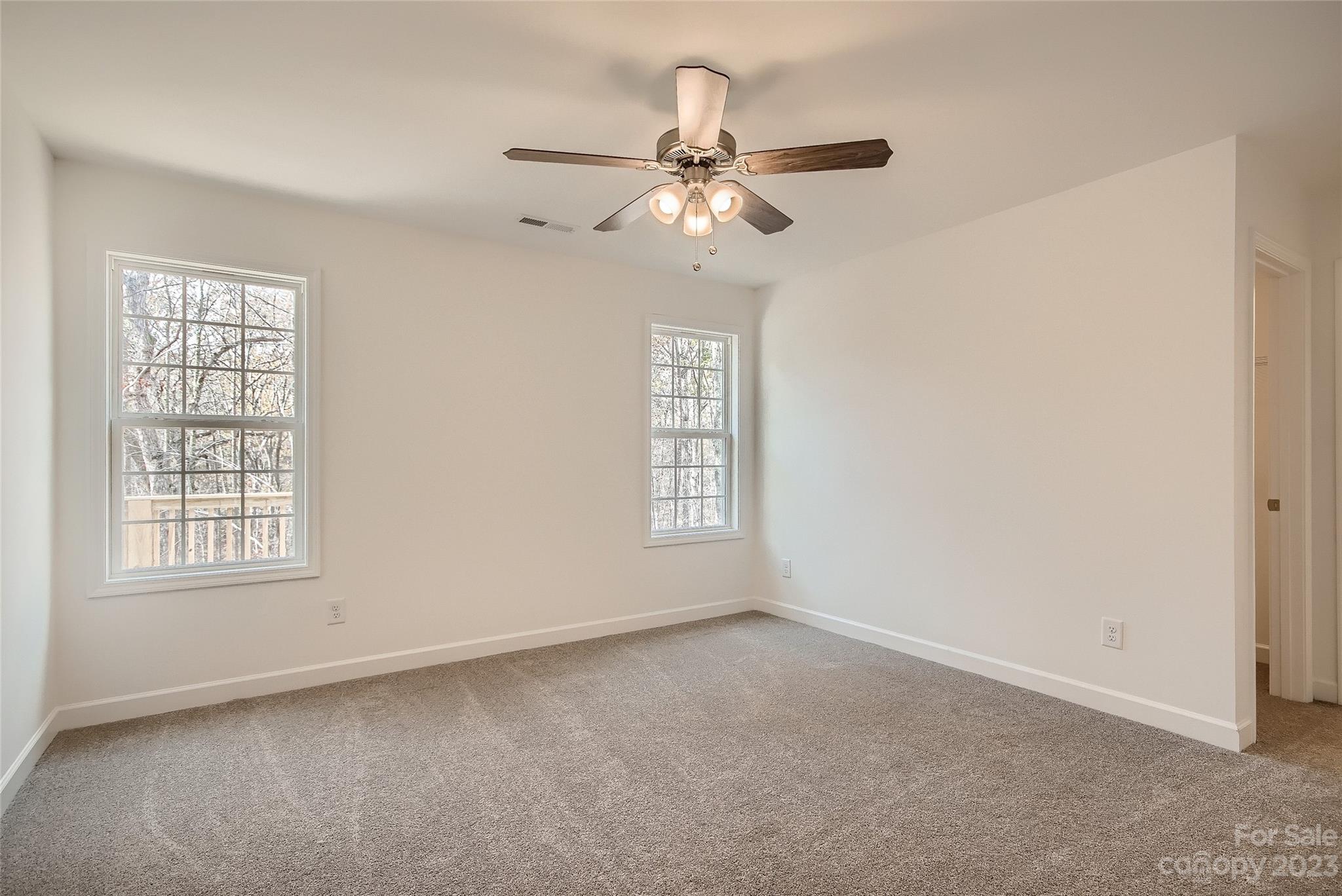1526 Shepard Street Kannapolis, NC 28083 - Photo 5 of 10 an empty room with chandelier fan and windows