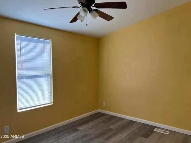 a view of a room with a wooden floor and a window