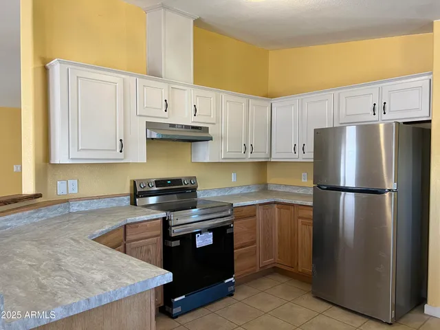 a kitchen with stainless steel appliances granite countertop a refrigerator stove a sink and dishwasher