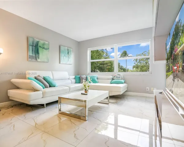a living room with furniture and a large window