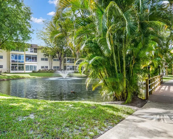 a view of pool with palm trees