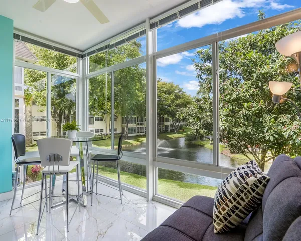 a living room with furniture and a floor to ceiling window