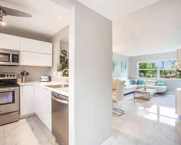 a kitchen with a sink and white cabinets
