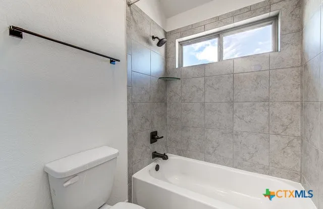 a bathroom with a sink a toilet and a bathtub