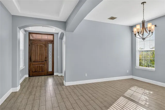 a kitchen with stainless steel appliances granite countertop a refrigerator a oven and a sink with wooden floor