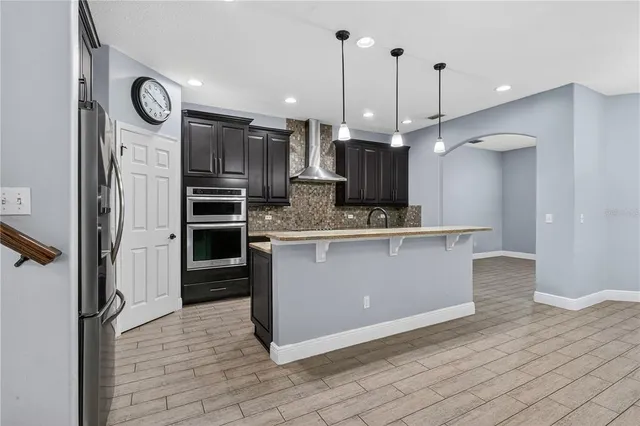 an empty room with windows and a chandelier