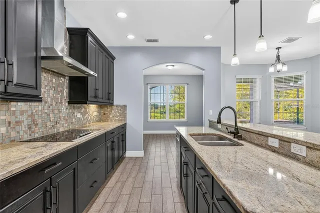 a kitchen with a stove a sink and a refrigerator