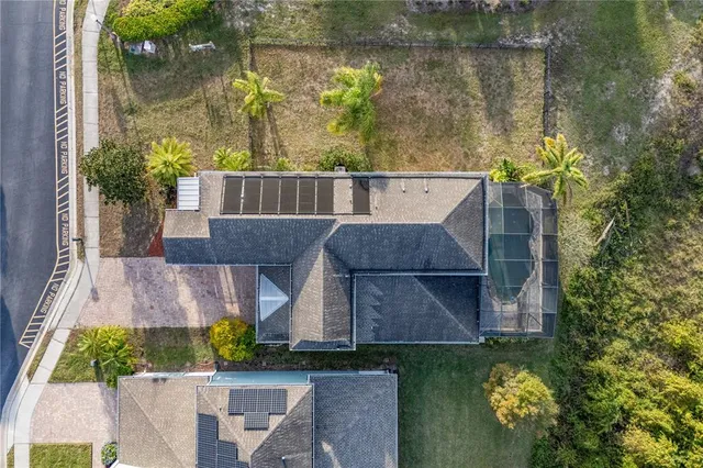 an aerial view of a house with a yard