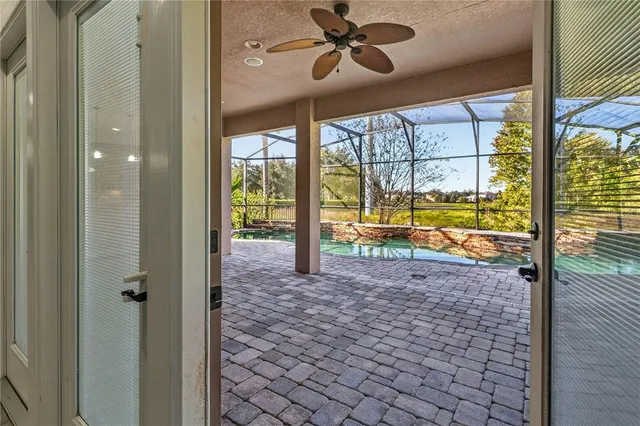 a view of a big room with wooden floor and a ceiling fan