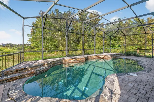 a view of a room with wooden floor and a ceiling fan