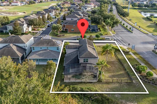 an aerial view of a house with a swimming pool lake view and mountain view