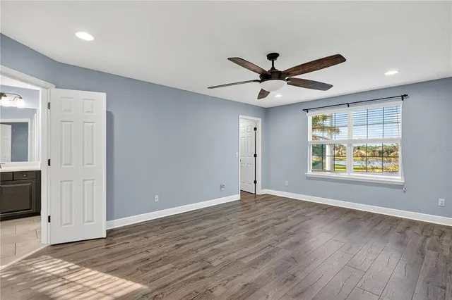an aerial view of residential houses with outdoor space and lake view