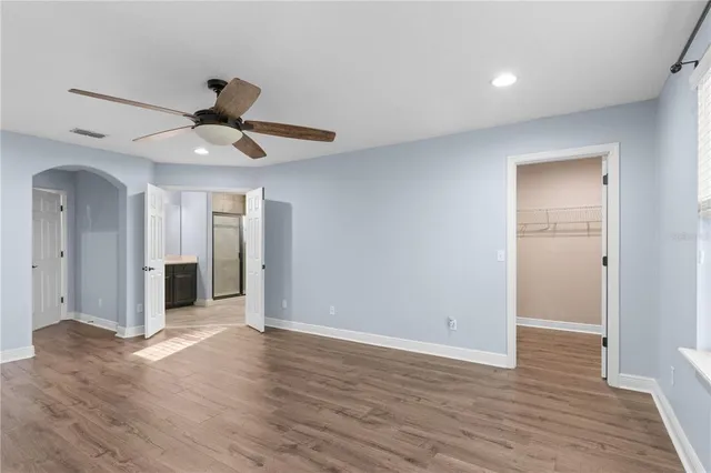 an aerial view of a tennis ground and a cars park side of the road
