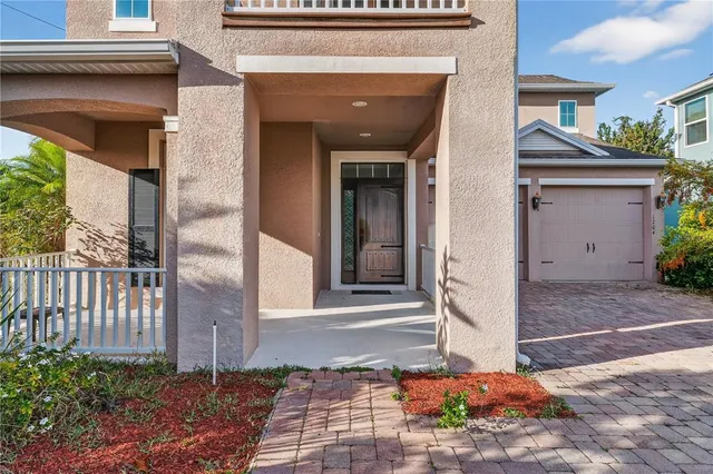 a view of an empty room with wooden floor and window