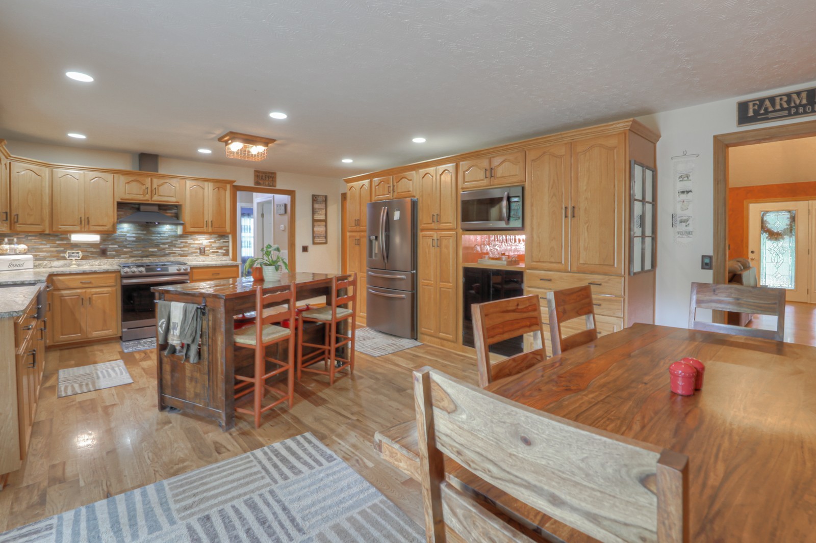 118 Robert Simmons Road Westmoreland, TN 37186 - Photo 22 of 82 a kitchen with stainless steel appliances granite countertop a stove top oven a sink dishwasher a dining table and chairs with wooden floor