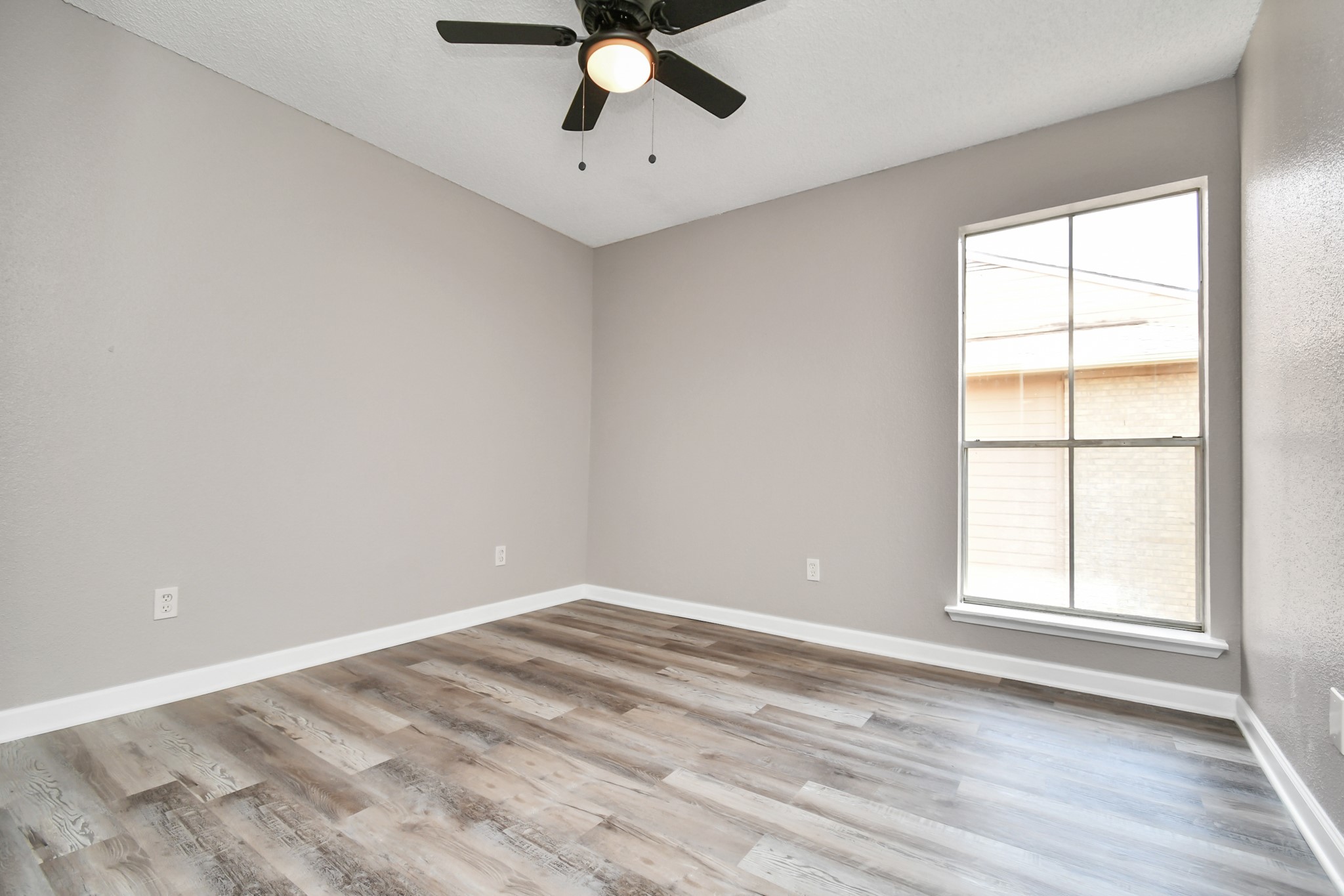 1505 Ward Road, Unit 182 Baytown, TX 77520 - Photo 11 of 20 an empty room with a window and a fan