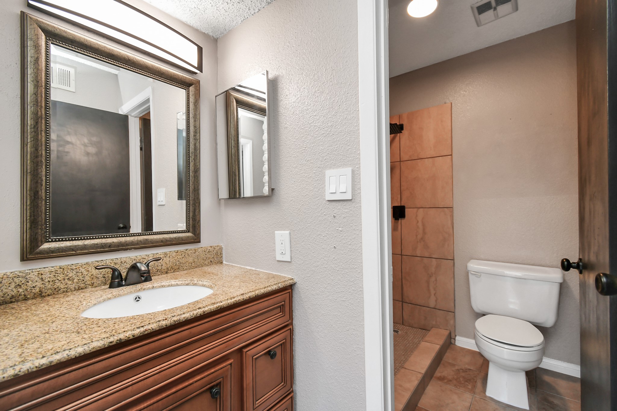 1505 Ward Road, Unit 182 Baytown, TX 77520 - Photo 14 of 20 a bathroom with a granite countertop sink toilet and shower
