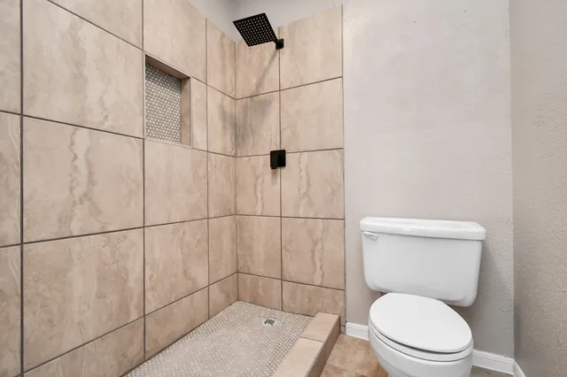 a white toilet sitting next to a bathroom sink