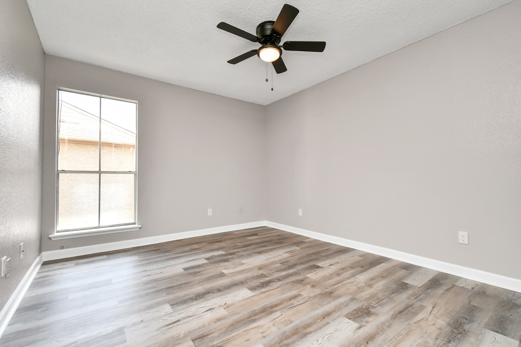 1505 Ward Road, Unit 182 Baytown, TX 77520 - Photo 8 of 20 an empty room with wooden floor and windows
