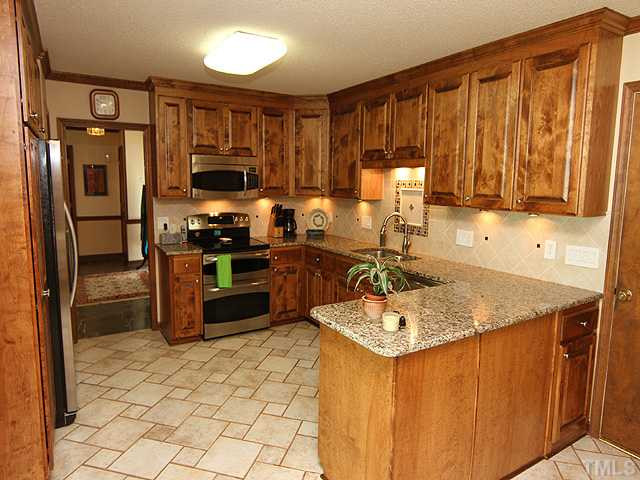 8829 Woodyhill Road Raleigh, NC 27613 - Photo 2 of 21 This kitchen was totally remodeled in 2011. It has granite, tile, stainless appliances. Many cabinet drawers for ease of getting to items along with turntables in corners. Very well thought out! Kitchen
