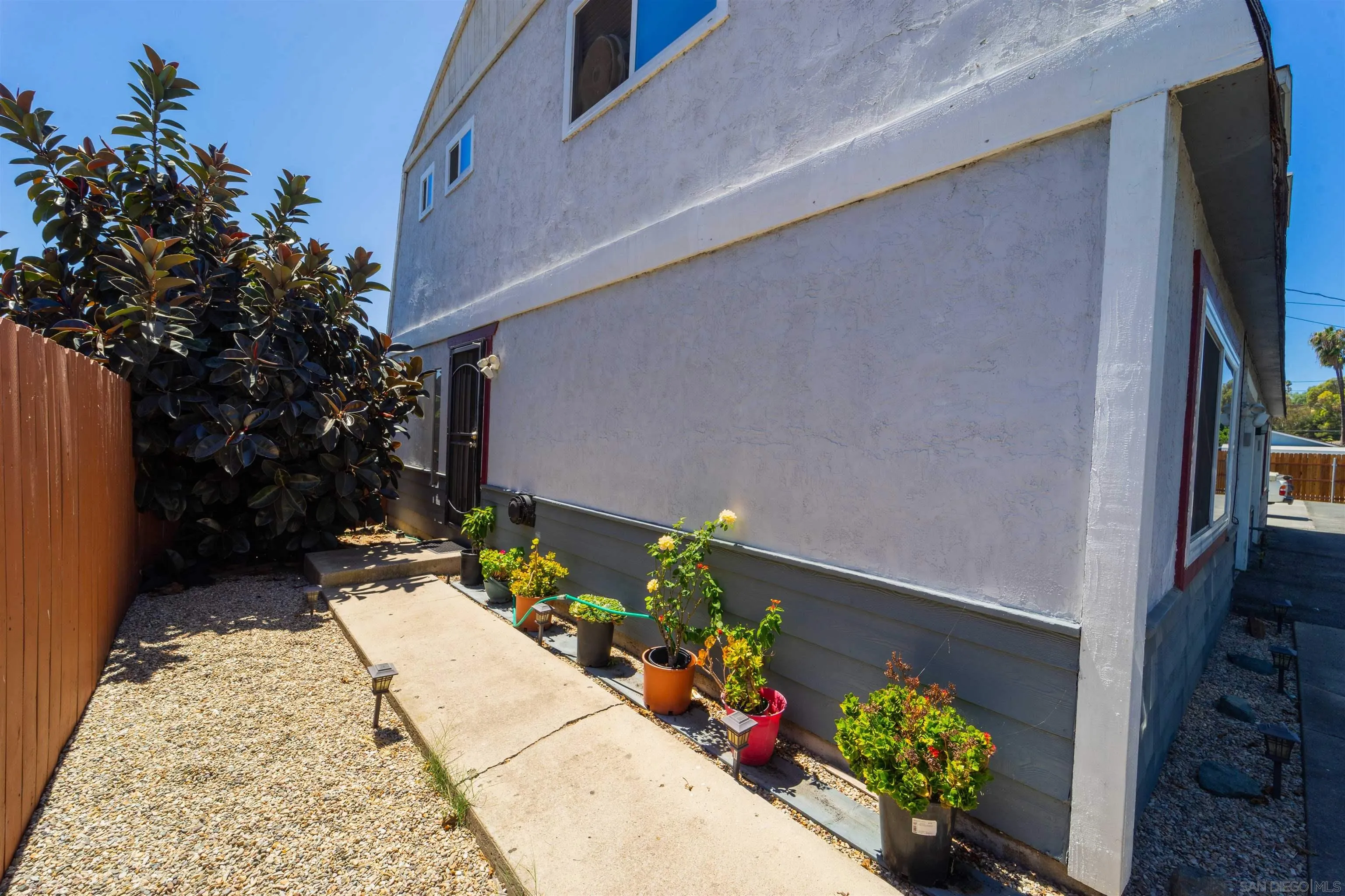 2259-61 Tyler Court Spring Valley, CA 91977 - Photo 2 of 7 a bunch of flowers in front of main door