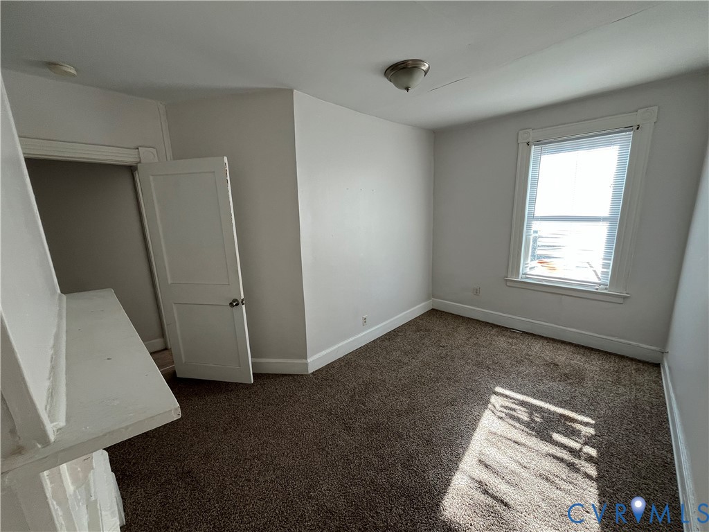 2316 R Street Richmond, VA 23223 - Photo 15 of 18 Spare room with baseboards and dark carpet