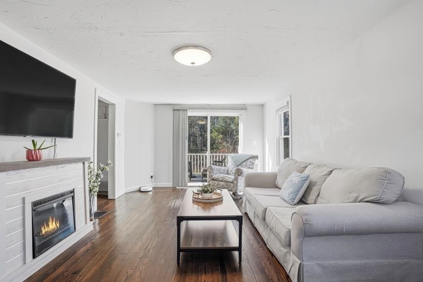 49 Grove Street Upton, MA 01568 - Photo 19 of 39 a living room with furniture a fireplace and a flat screen tv