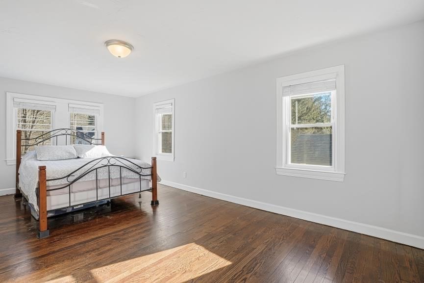 49 Grove Street Upton, MA 01568 - Photo 23 of 39 a bedroom with a bed and wooden floor