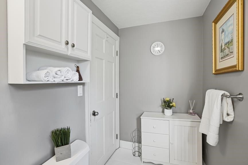 49 Grove Street Upton, MA 01568 - Photo 27 of 39 a white painted room with a window and flowerpot