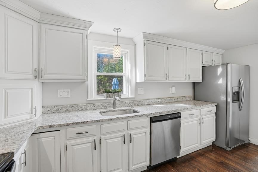 49 Grove Street Upton, MA 01568 - Photo 5 of 39 a kitchen with stainless steel appliances granite countertop a sink a stove a refrigerator and white cabinets with wooden floor