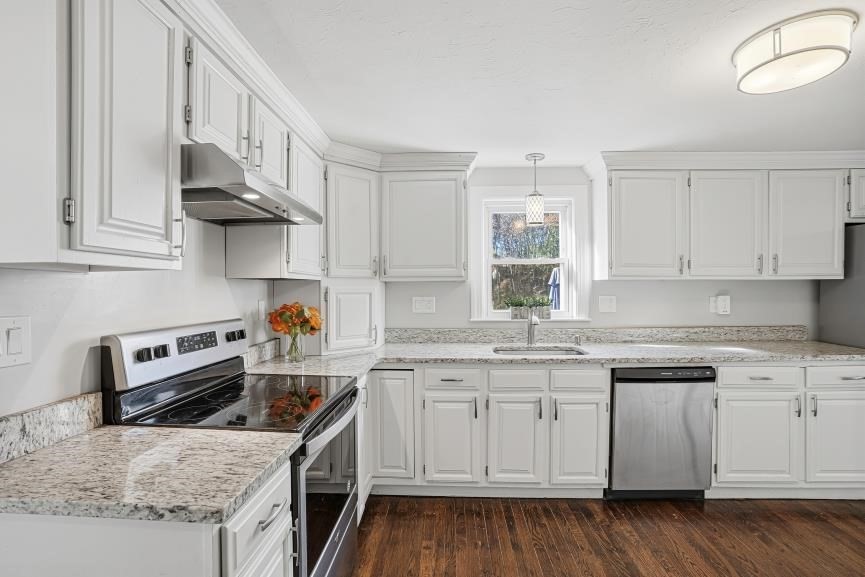 49 Grove Street Upton, MA 01568 - Photo 6 of 39 a kitchen with granite countertop a sink a stove and cabinets