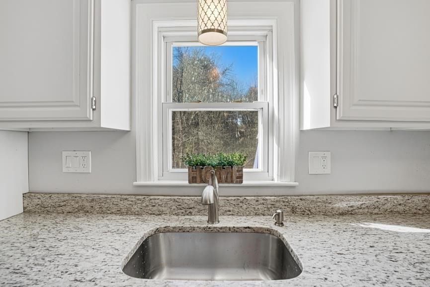 49 Grove Street Upton, MA 01568 - Photo 8 of 39 a kitchen with granite countertop a sink and a window