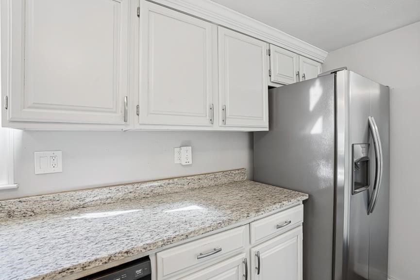 49 Grove Street Upton, MA 01568 - Photo 10 of 39 a kitchen with granite countertop a refrigerator and cabinets