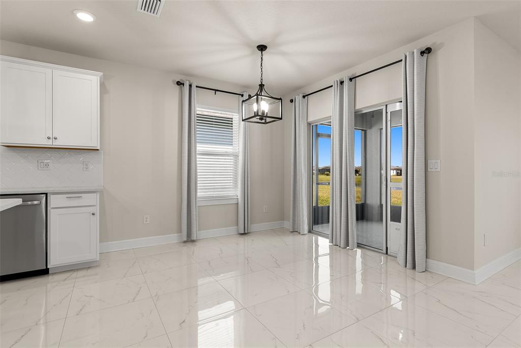 9256 Royal River Circle Parrish, FL 34219 - Photo 13 of 38 a view of a kitchen with refrigerator and dryer